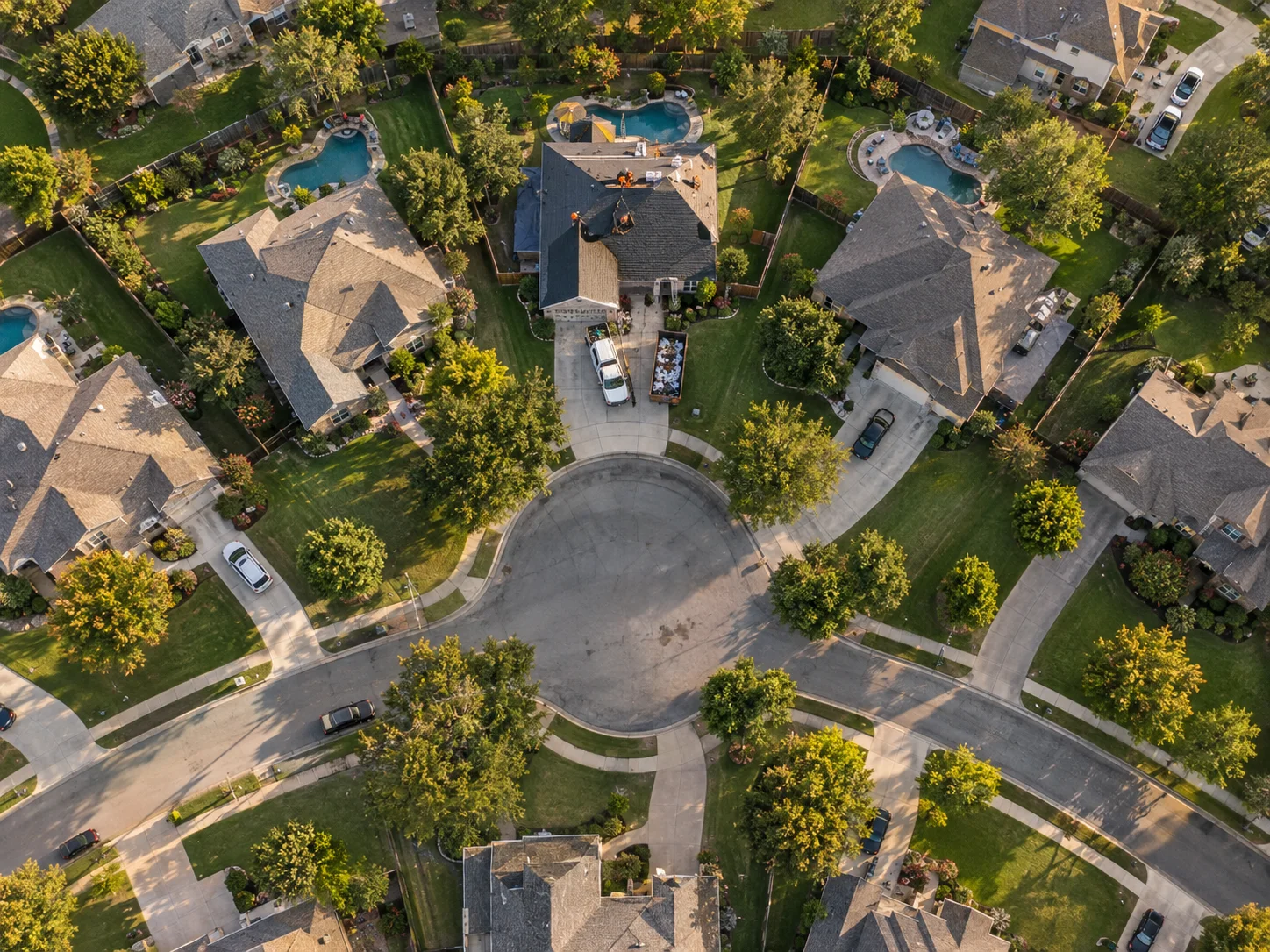 Aerial view of a roofing job on a cul-de-sac with the surrounding homes circled